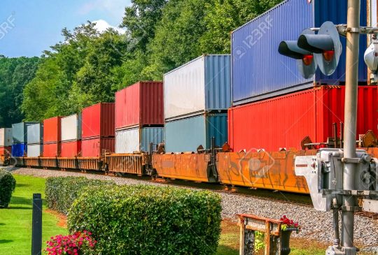 Colorful Freight Train across railroad crossing in Norcross, Georgia